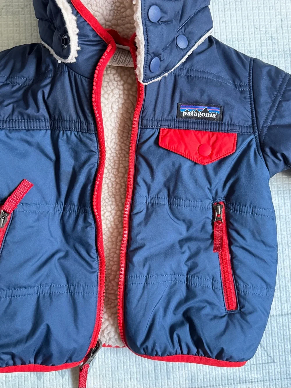Patagonia Kids Navy Jacket with Red Trim and Cream Sherpa Lining